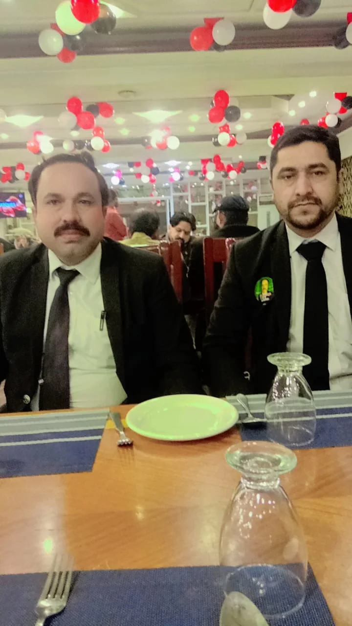 Ch. Abdulrab Manda with a fellow lawyer at a professional dinner event
